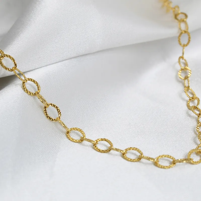 Gold link chain on fabric